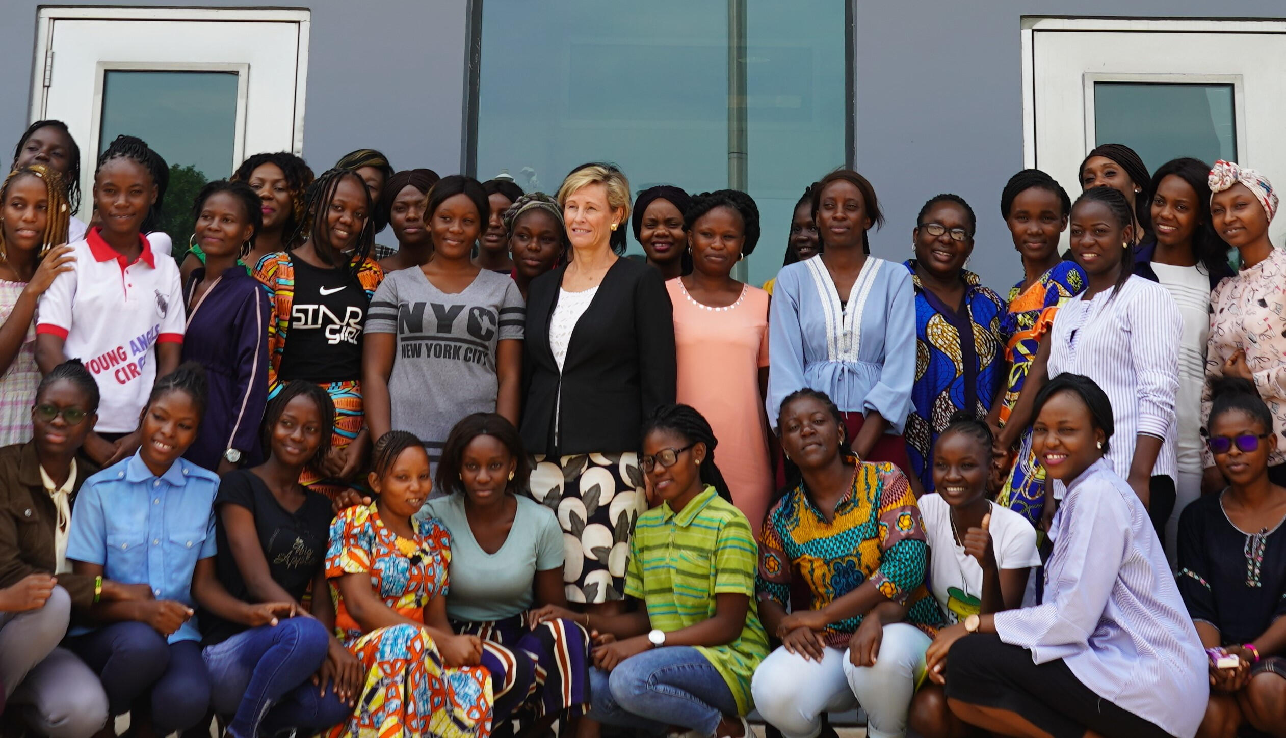Photo of a group of women from the Republic of Congo after a workshop standing in front of a building. Jennifer is standing in the middle of the frame.